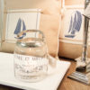 Lene Bjerre - Windlicht aus der Tradition Collection mit Tischlampe aus der Carmina Collection und Jute-Kissen mit Segelschiff